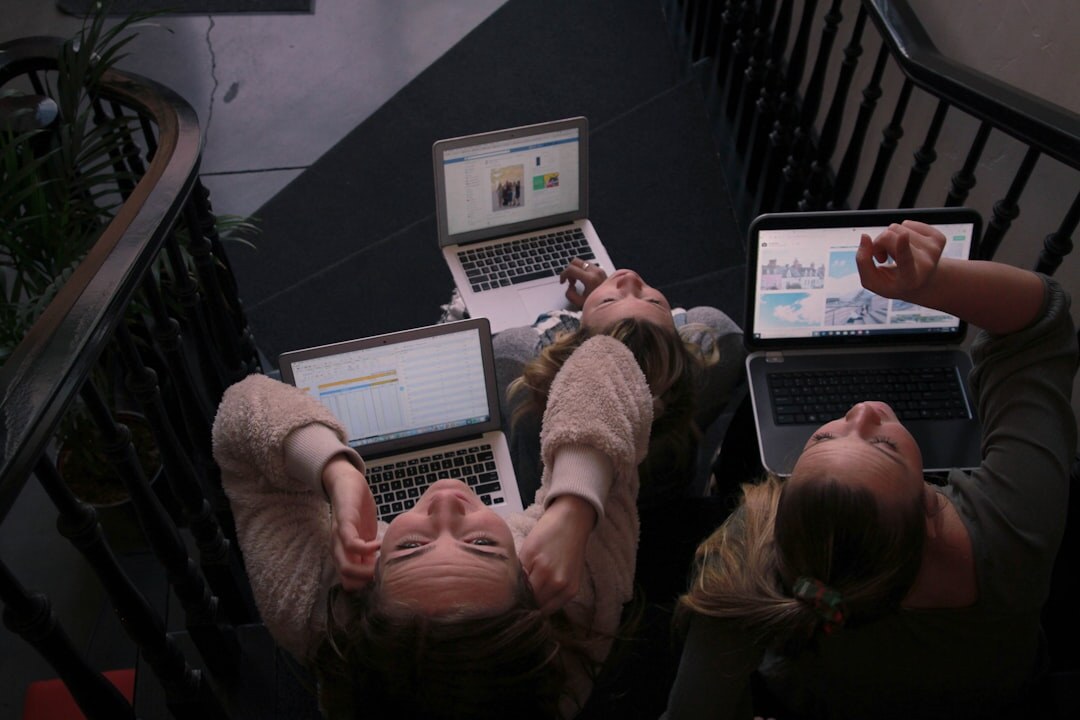 Newsroom team analyzing data on multiple screens