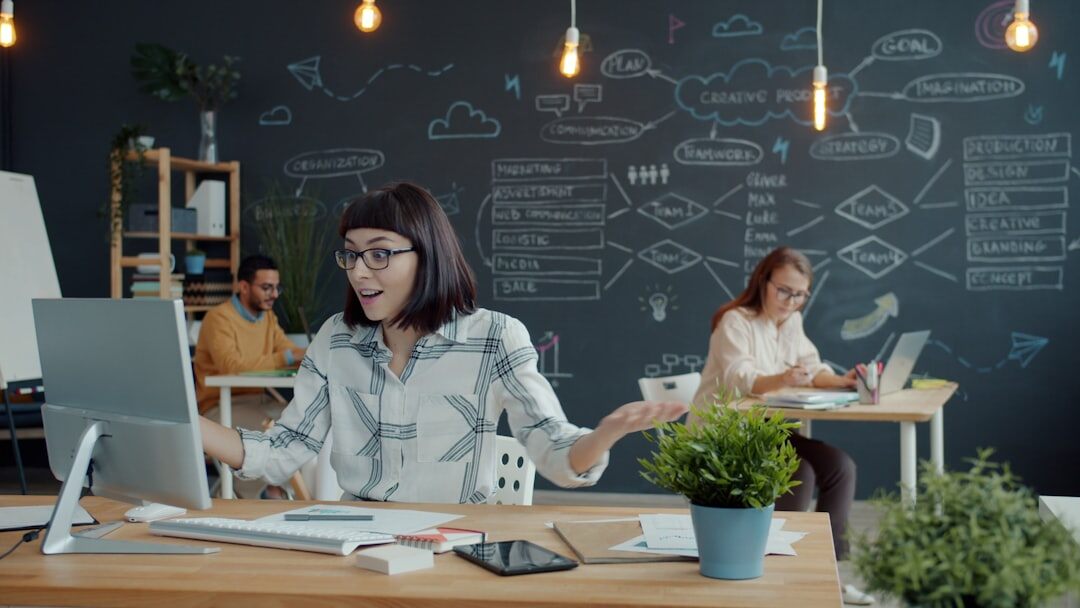 Modern open-plan media office with employees working